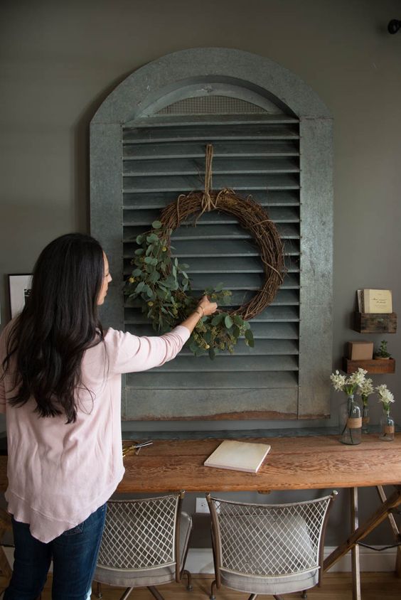 simple grapevine wreaths, filled them with fresh and faux greenery. When making your own wreath, you can use fresh greenery that will dry pretty, like seeded eucalyptus, or faux greenery, like these olive stems