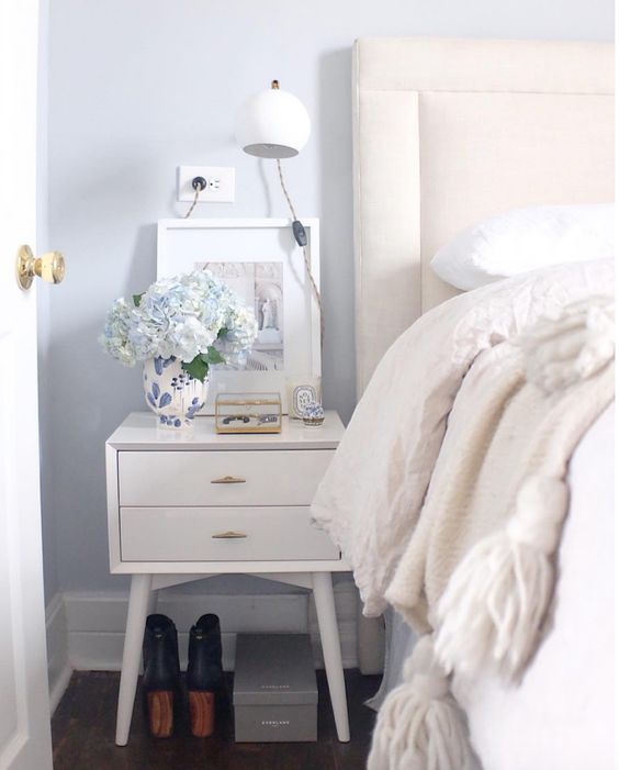 simple nightstand styling white and blue bedroom with tassel throw