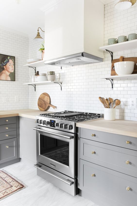 Small kitchen with white backsplash and gray cabinents