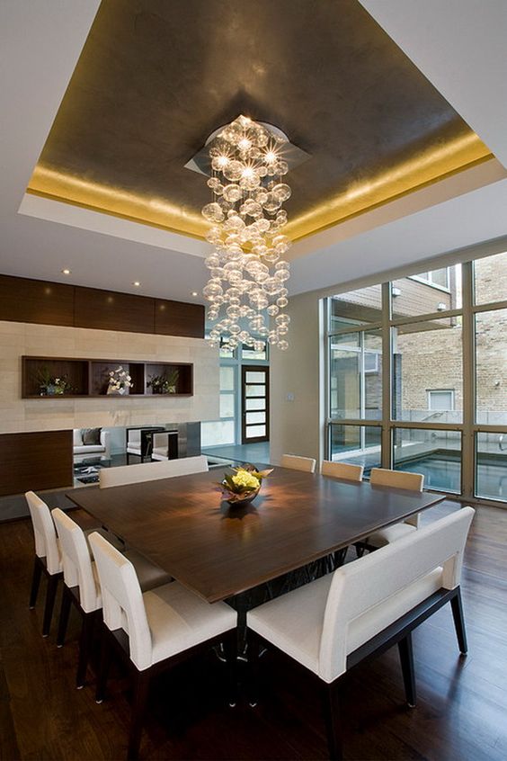 Square table and uber cool hanging light fixture/ Chandelier. Modern lighting. Wall of windows in the dining room. 40  Beautiful Modern Dining Room Ideas