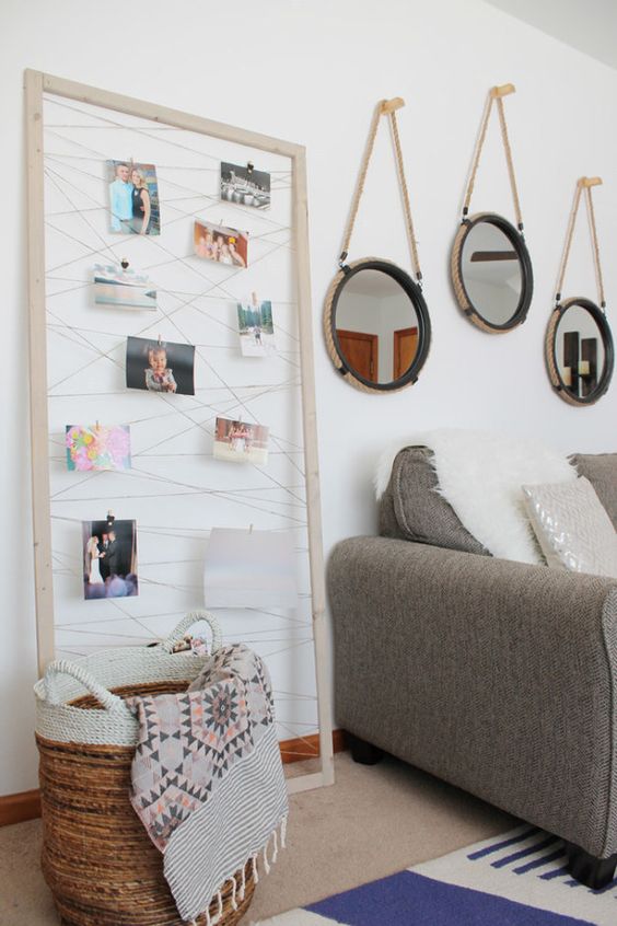 Staple or glue twine to the back of a thrifted frame, then use clothespins to hang up your prints. | 19 Gorgeous Ways To Display Your Favorite Travel Photos