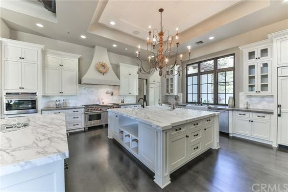 The amazing kitchen is a home chef's fantasy with its top-line appliances, white cabinetry, and sleek marble countertops.