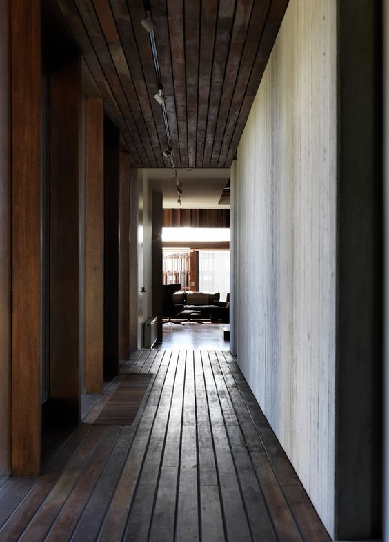 The materiality of the interior displays a connection to the surrounding environment through the use of the dark hardwood. In addition this hallway creates a private space within the house used only by the residence.
