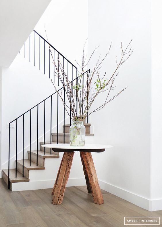 There is always room for natural elements in any decoration. Here we have an ultra clean and modern canvas, with textures from a reclaimed wood table base and willow branches as an arrangement.
