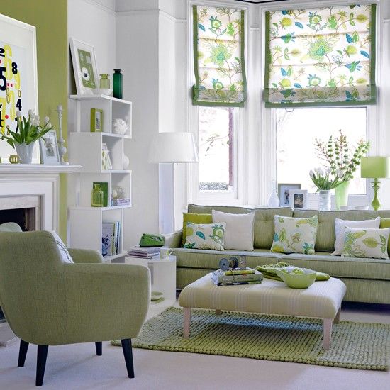 This white and green living room is alive with style. very inviting, great patterns and accents, modern furniture. Really like this space.