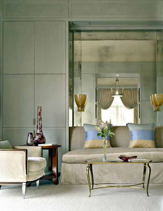 Vintage & Modern Chic Living Room. Good way to add storage with style. Like the hurricane style sconces.