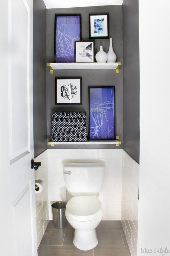 Water closets don't have to be boring. Take the focus off the toilet with tile, (faux) marble shelves, and art. This entire graphic glam bathroom makeover is a must see.