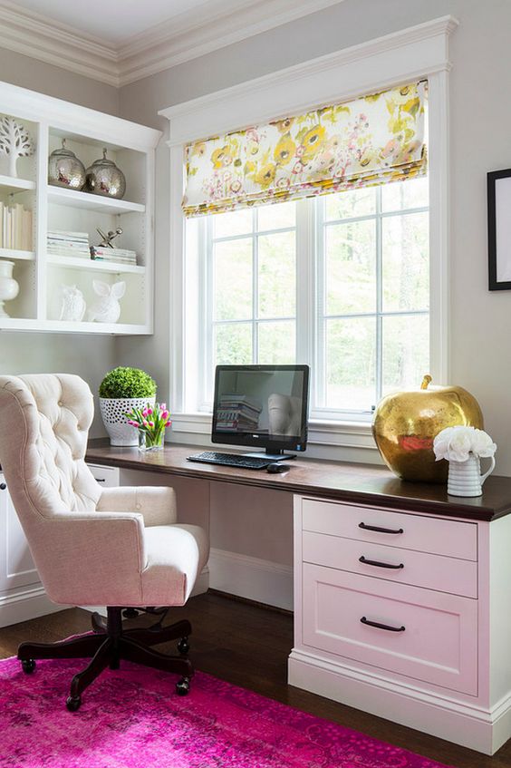 White room with dark-stained floor and desktop and bright magenta rug. Comfy-looking chair. You'd have to pull down the shades in order to see the screen, of course. Design: Martha O’Hara Interiors.