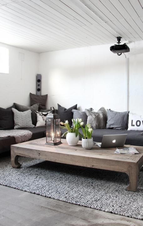 White/grey living room with wooden details. And a lovely lantern!