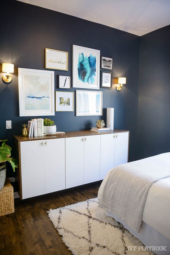 A bold wall color (like this moody navy!), looks great brightened up with white and gold accents from HomeGoods. Love the marble vase and white planter on top of the dresser. (Sponsored Pin)