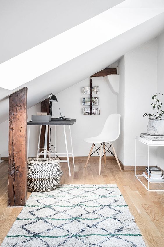 Attic masterfully repurposed into a study in this stunning Swedish apartment