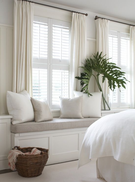 bedroom with window seat in soothing shades of white