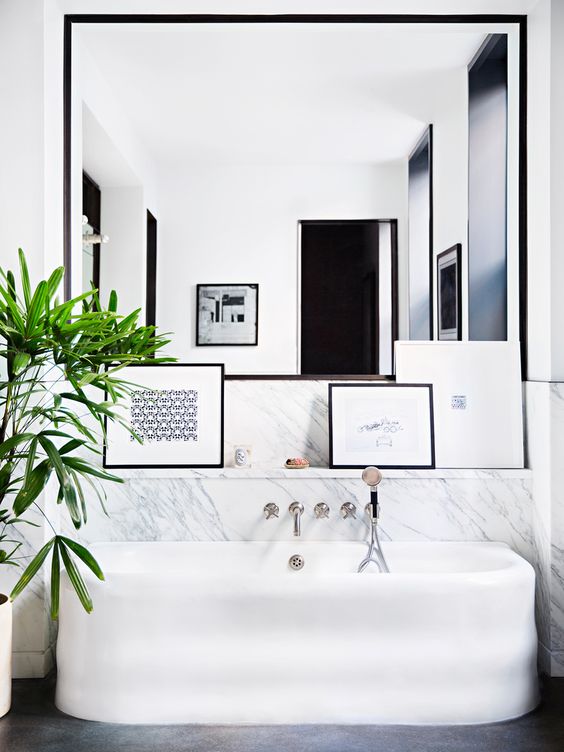 Modern bathtub in a black and white bathroom