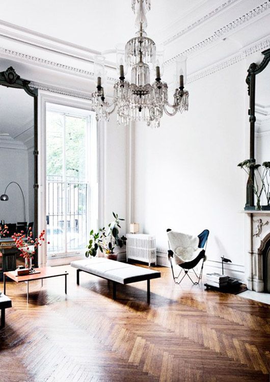 modern living room with ornate balck mirrors, crown molding and vintage chandelier / sfgirlbybay