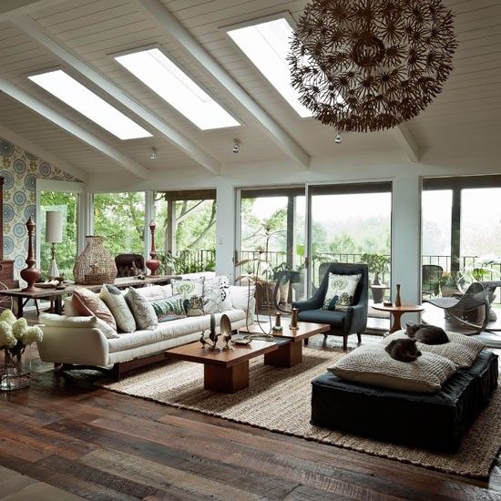 Modern wood living room. This nature-inspired living room changes with the seasons. In summer, the doors to the deck open up and the view comes inside. In winter, the soft furnishings and fireplace create a cosy feel.