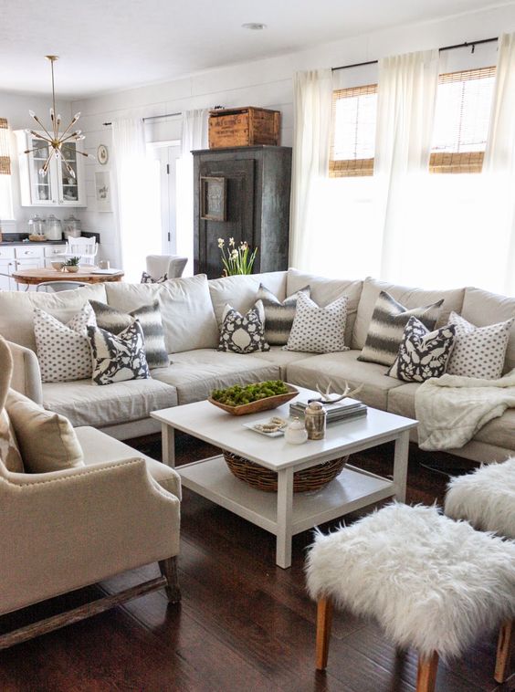 neutral living room with sectional, patterned pillows, ikat, fur, white