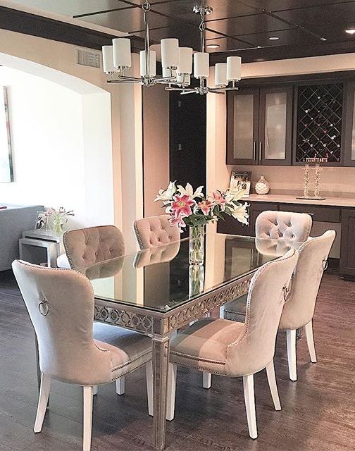 Our Sophie Mirrored Dining Table elegantly reflects its surroundings to merge glamour with modernism. Our Charlotte Dining Chairs are a textured touch. Photo via @tanyafarahinteriordesign.
