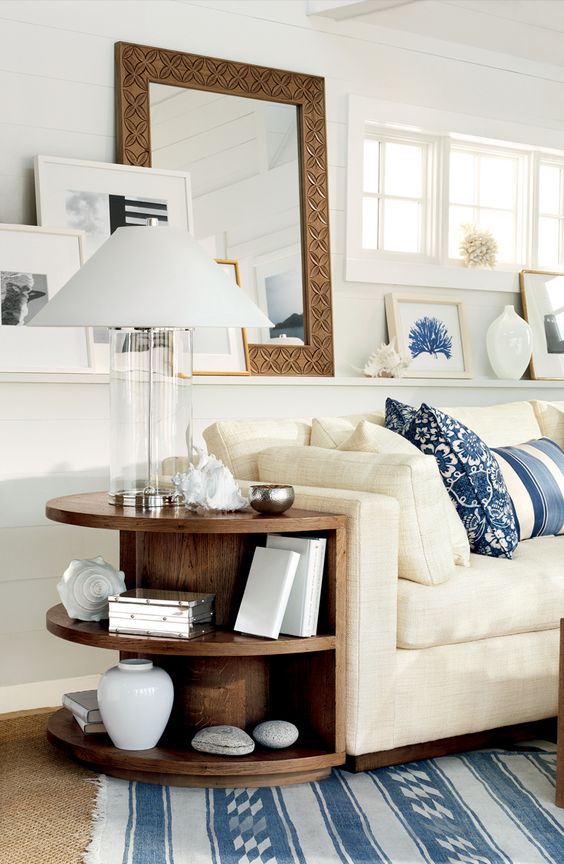 Ralph Lauren Home's Driftwood Sofa and nautical decor transform a living rom into a soothing retreat by the ocean