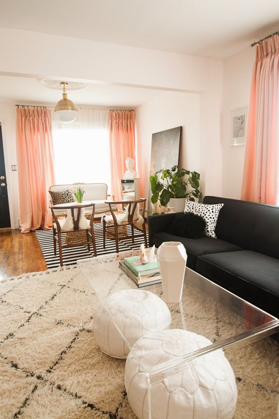 Spotted: Peekaboo Coffee Table || Peachy pink floor to ceiling drapes add color in this otherwise neutral living space. black, white, pink, and leopard with accents of lucite and gold. glamorous and feminine and pretty.