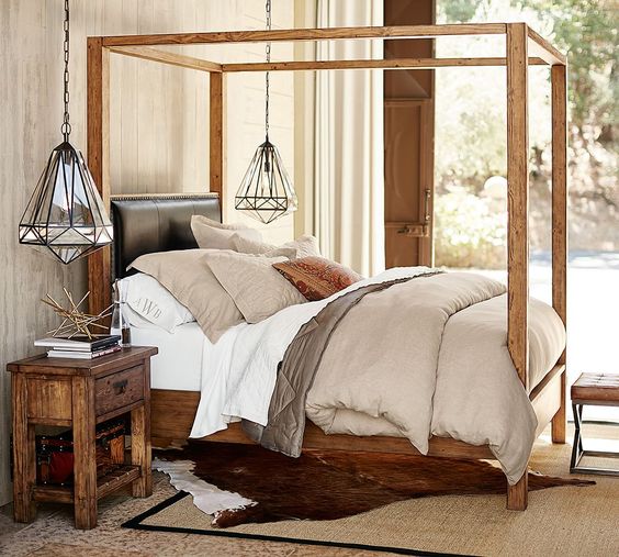 The classic four-poster bed gets updated with a sleek wood profile. The warm of the wood is only enhanced by the textured hand of the linen to create a bed that is a little classic, a little rustic but definitely stylish and comfortable.