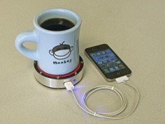Epiphany One Puck charges your phone using heat transfer. Apply heat (hot beverage) to red side or cold (iced beverage) to blue  phone. fun. yay science!