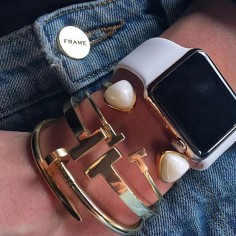Fashion Insiders and Celebrities With the Apple Watch - model Karlie Kloss wearing frame denim, gold arm candy, and a white Apple watch