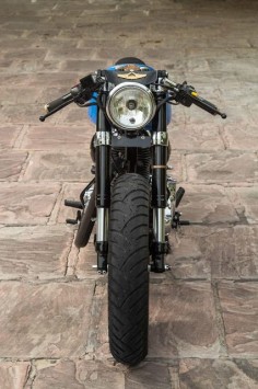 From  - 500cc Royal Enfield Cafe Racer commisioned for 'Numero Uno Jeanswear'. Rebuilt 80% of the frame, Rubber mounted engine, Mononshock rear swingarm, KTM forks, Denim clad seat, Brass Details.