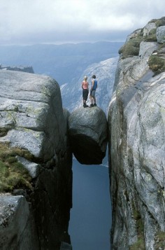 Kjeragbolten boulder wedged in a mountain crevice in the Kjerag mountains in Norway.