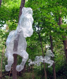 made out of packing tape, installed on trees like a forest carousel