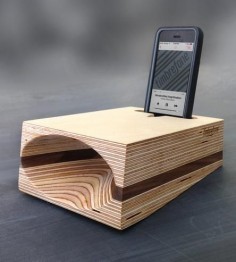 Portable, powerful and made from natural material, this phone speaker projects the sound from your smartphone without the use of cords, batteries or a digital connection. Baltic birch plywood and a contrasting layer of walnut or mahogany are smoothed into an angled wedge shape, hollowed with a uniquely curved acoustic cone, amplifying sound with a warm, full tone.