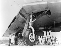 STRANGE OLDE MILITARY PHOTOS - UNIQUE SHOT OF" FLYING WING" UNDERSIDE - FRONT WHEEL CHOKED AND READY FOR MAINTENANCE