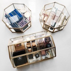 A chic way to store your makeup. Mix and match glass boxes for an eclectic look.