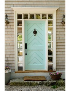 A front door can be a lovely way to pay homage to the home’s locale. Here an inlaid chevron panel detail, duck’s-egg blue color, and ship-lantern sconces all lend a seaside New England feel. 7 Fabulous Front Door Ideas