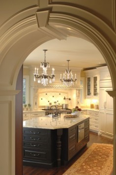 A kitchen fit for a king; beautiful archway entrance, chandelier lighting, beautiful wooden counters, and fantastic marble counter tops!