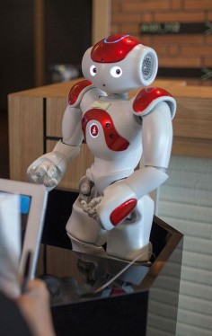 A robotic concierge handles guests' questions at the Strange Hotel.