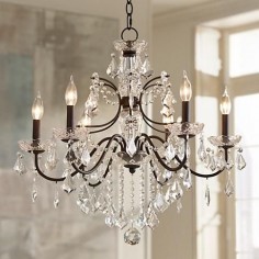 Adorned with a bronze finish and paired with clear crystals, this chandelier adds class and sophistication to any space.