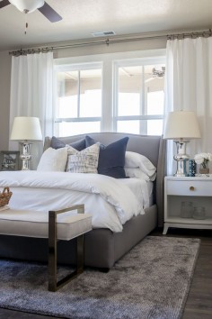 Alice Lane Home Collection | Daybreak Lake Loft | Gray upholstered bed in Master Bedroom, white bedding and neutral decor | Lindsay Salazar Photography