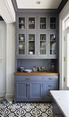 An old, dark kitchen get's a bright new makeover with beautiful blue and white tile floors, spacious cabinet storage and lots of natural light.