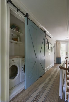Barn door Laundry. I wonder if this would be easier than doing a pocket door. (Love the door color too!)