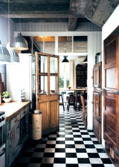 black and white checkered floor with old wooden doors and pendant lighting