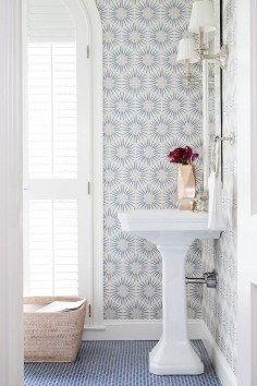 Bright bathroom mis-match printed tile and a white pedestal sink