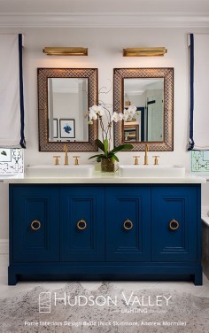 Bring the unexpected into your bathroom. Go for the colors you crave. And when it comes to lighting? Be brave. Here, our Merrick picture light serves as a vanity sconce. You can find more here.