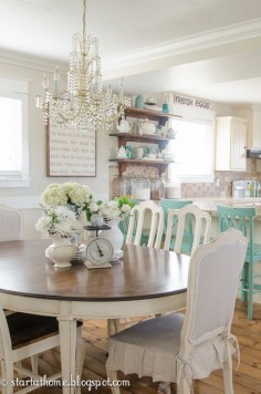 Cottage farmhouse style, decorated in shades of white cream and aqua. Dining area & kitchen.