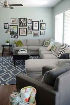 EXACTLY what I want for the living room (reversed)! Sectional couch against  And family photos on side wall :D