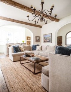 exposed beams in living room with chandelier