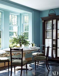 Farrow & Ball’s Ballroom Blue paint brightens the breakfast area of a Connecticut home decorated by Miles Redd. Antique chairs flank a custom-made table by Redd.