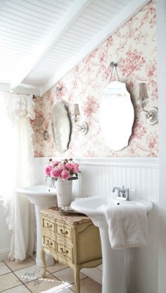 French Country style bathroom with toile wallpaper and scalloped mirrors over dual pedestal sinks design bathroom ideas home decor @Lamps Plus