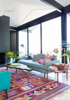 graphic and colorful mid century modern living room with blue sofa