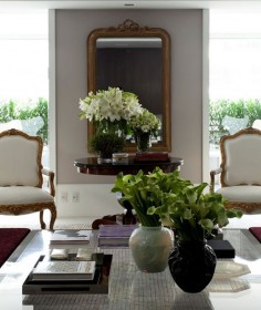 Green and white floral arrangements in traditional room