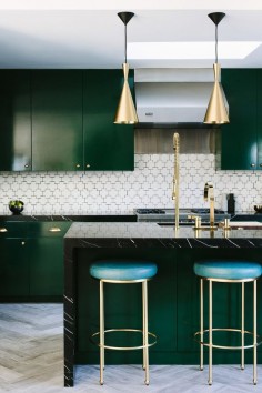 Green cabinets and gorgeous brass accents.